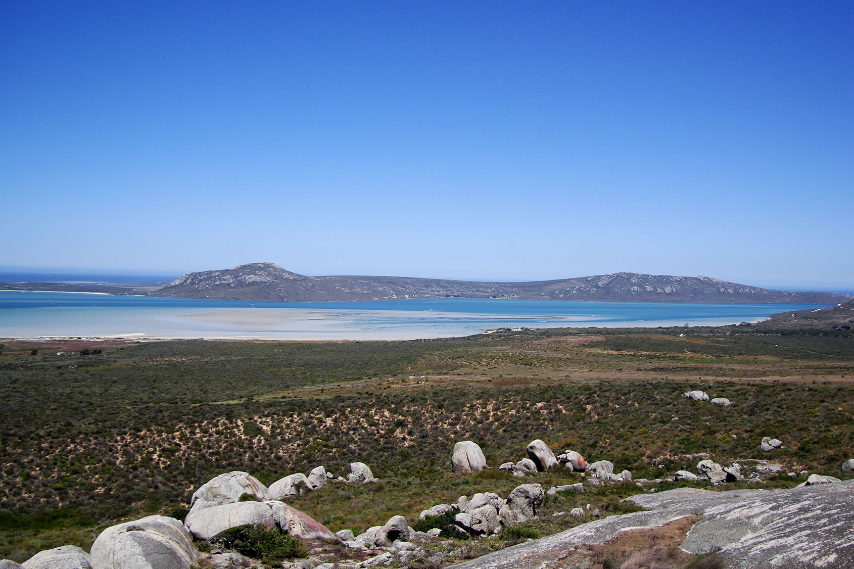 Turquoise water, fynbos and granite rocks at Langebaan Lagoon.