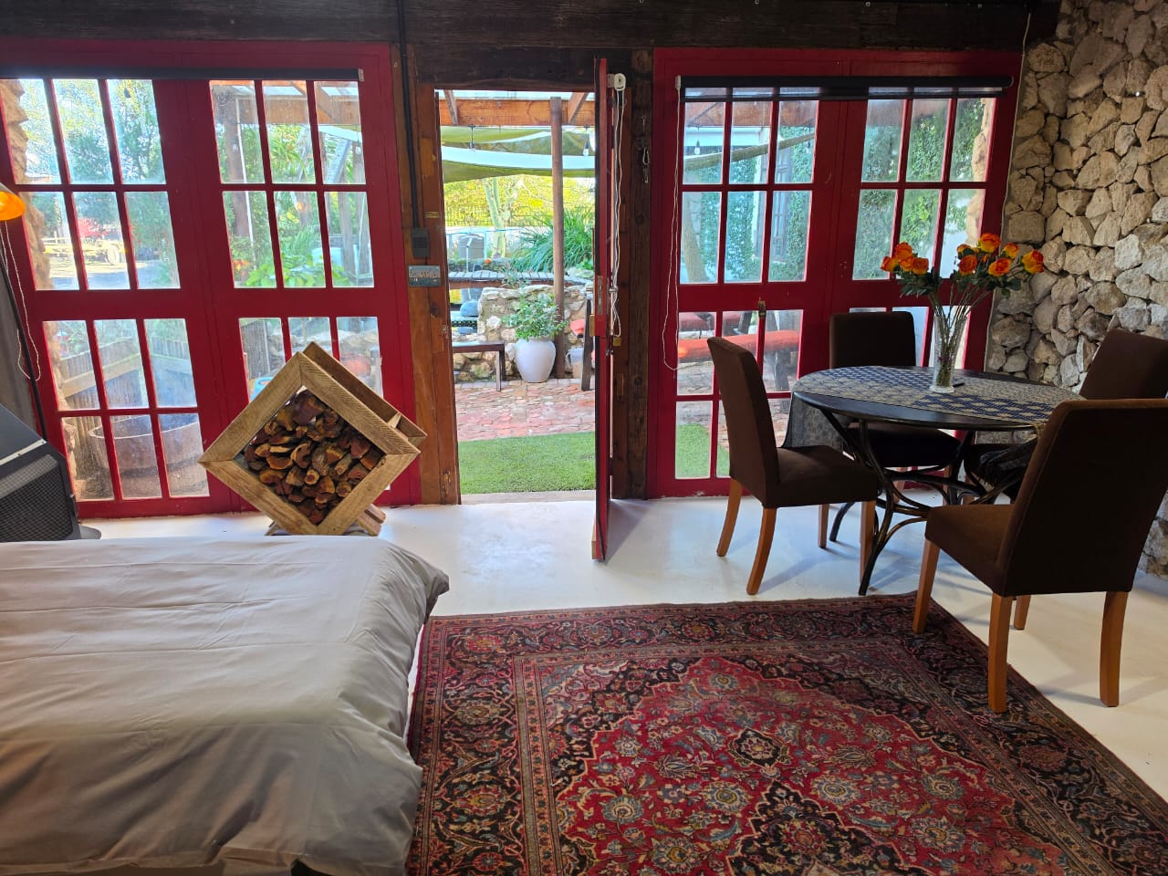 The Black Swan Rest bedroom and dining nook opening onto the courtyard.